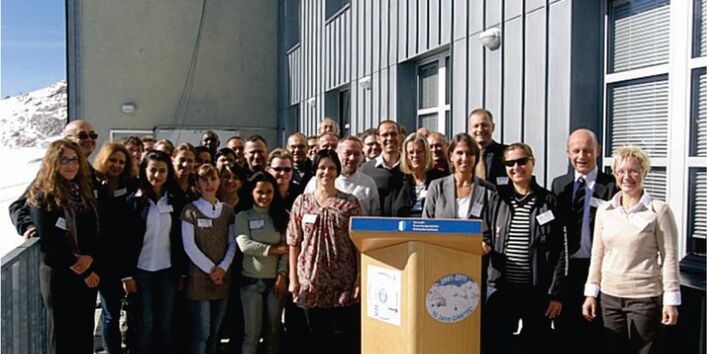 Global Atmosphere Watch Training & Education Centre (GAWTEC) celebrates 10th anniversary: a group of persons standing in front of a house