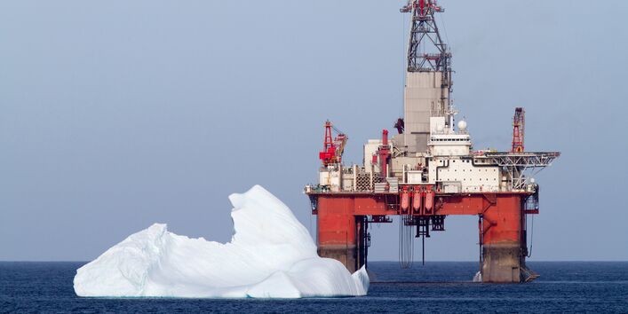 Eisberg in der Nähe einer Bohrinsel