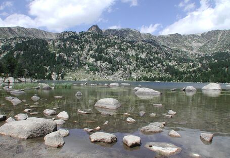A clear-water lake, surrounded by high mountains 