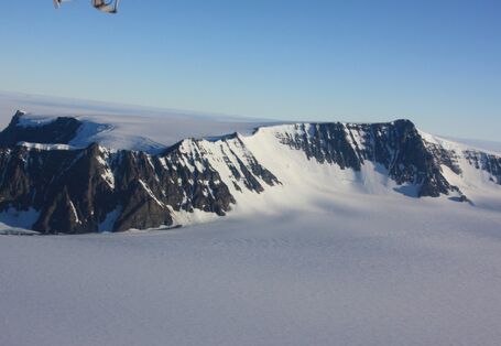 Die unendliche Weite der antarktischen Eiswüste wird nur durch einige Bergspitzen unterbrochen.
