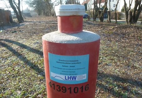 auf einem Feld ist eine Grundwassermessstelle zu sehen