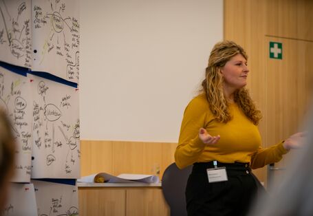 Alena Büttner vom UBA steht vor einer Pinnwand, die Diskussionsbeiträge zusammenfasst