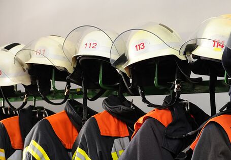 Aufgereihte Jacken und Helme der Berufsfeuerwehr