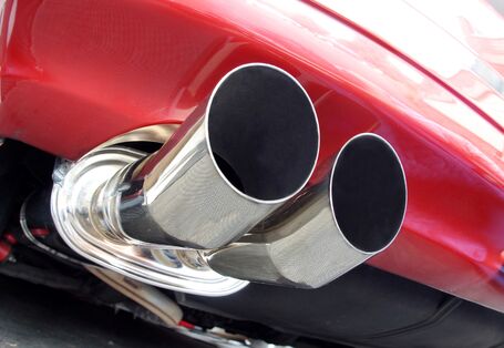 red car with silver exhaust in close-up