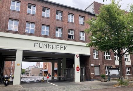 Brick building, "Funkwerk" is written above the large gateway