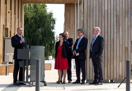 Mann im Anzug am Rednerpult im Freien vor dem Haus 2019