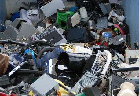used electrical and electronic equipment in a container, for example monitors, computers and household appliances