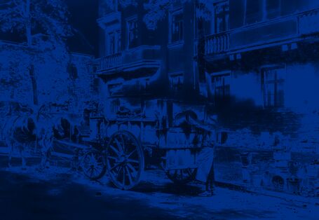 Ein Arbeiter entleert einen Eimer au offene Ladefläche eines Pferdewagens.