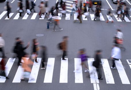 pedestrians are crossing a street on an cross-walk