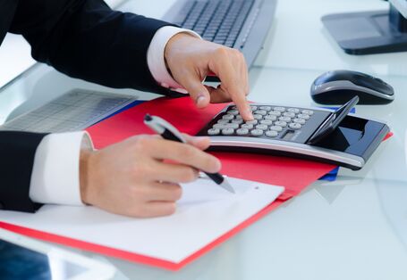 A man with the calculator calculates the costs.