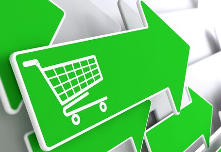 mehrere grüne Pfeile, die in eine Richtung weisen, einer davon mit der Abbildung eines Einkaufswagens