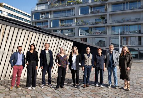 The jury posing in front of a building