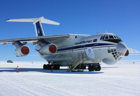 The white Ilyushin for passengers and behind a pickup