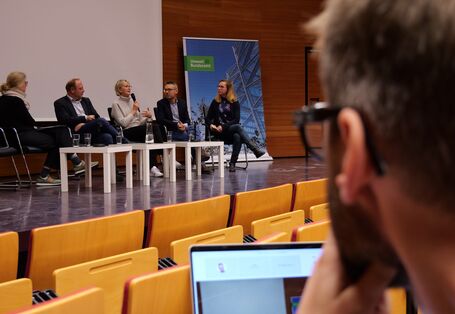 Ein Bild im UBA-Hörsaal in Dessau mit Menschen auf dem Podium während einer Veranstaltung.