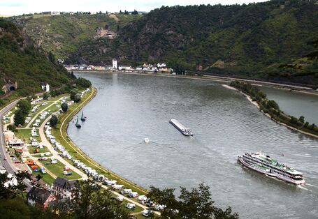 Rheintal: auf dem Wasser ein Ausflugsdampfer und ein Transportschiff