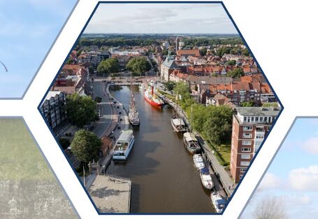 Der Blick trifft aus der Höhe auf einen Fluss, der durch eine Stadt fließt.