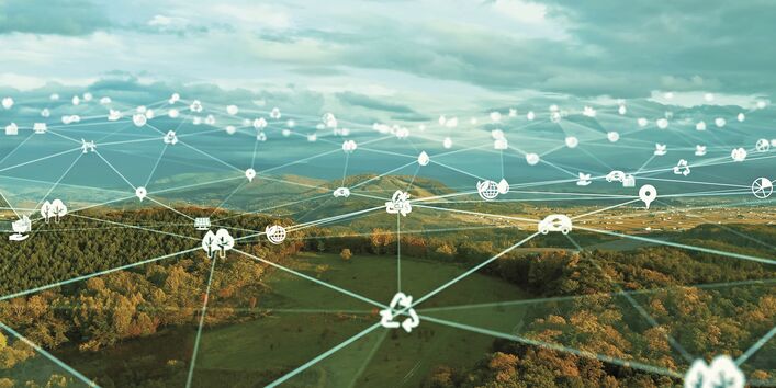 The image is directed towards the sky against the sun and shows a circle of ten stretched hands in a circle.