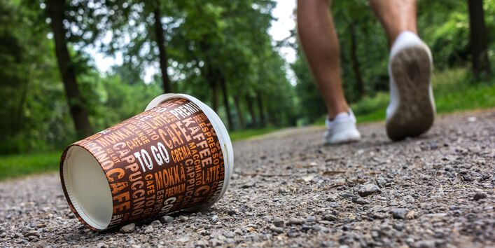 A coffee cup in the woods.