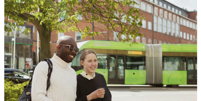 a young women and man walking in a city