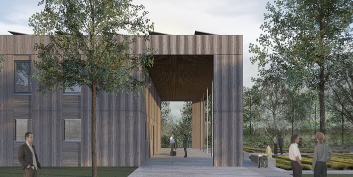 kubusförmiger Holzbau mit Arkaden und Solarzellen auf dem Dach