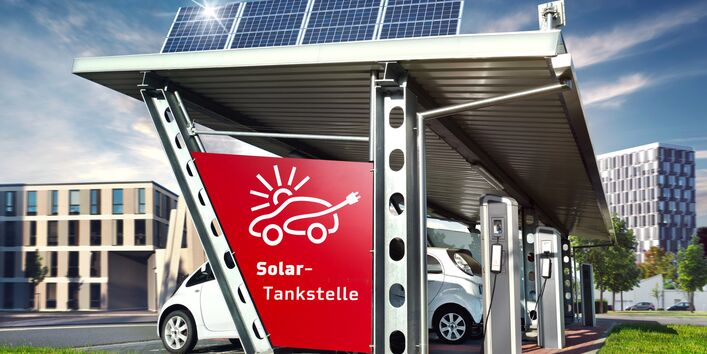 computeranimiertes Bild einer Solartankstelle in der Stadt: auf dem Dach befinden sich Solarmodule, unter dem Dach parken Autos, die Strom tanken