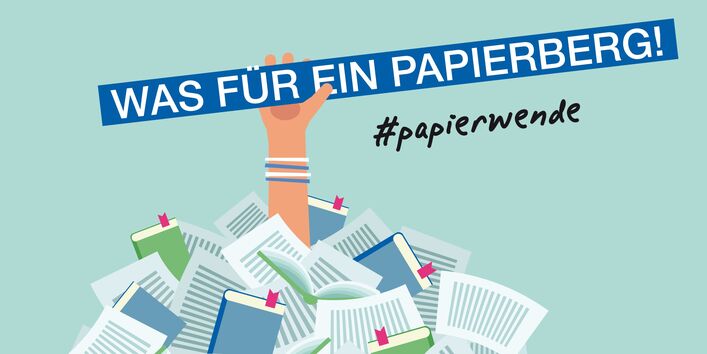 Comicbild: aus einem Papierhaufen hält eine Hand ein Schild hoch: Was für ein Papierberg!
