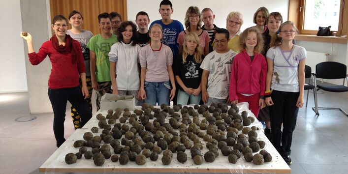 Eiruppenfoto der Kinder aus der Regenbogenschule mit den Samenbomben
