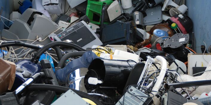 used electrical and electronic equipment in a container, for example monitors, computers and household appliances