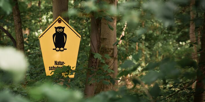 Naturschutzgebiet-Schild in einem Wald
