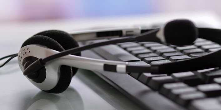 Kopfhörer liegt auf Computertastatur