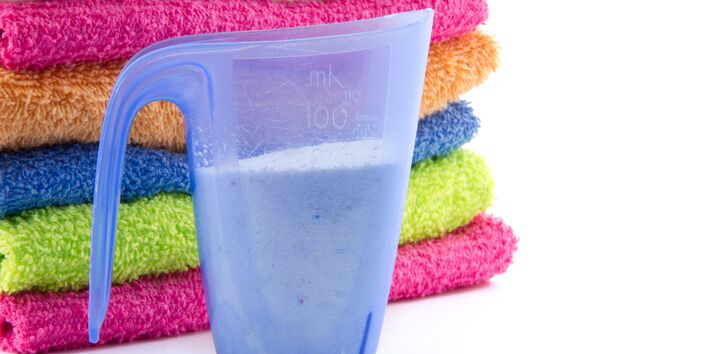 measuring cup for laundry detergent and towels in different colours