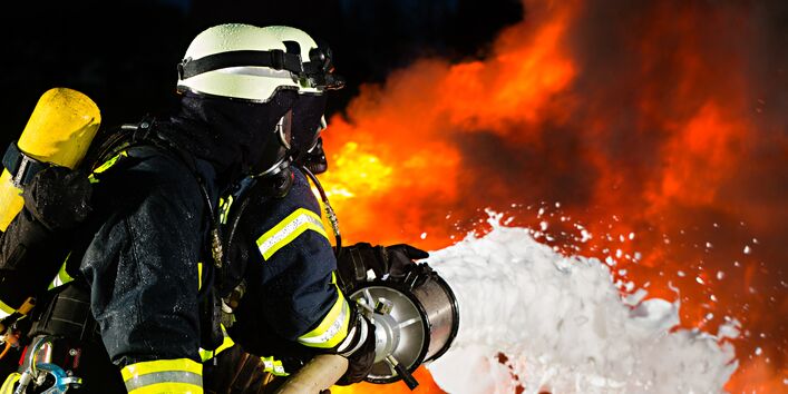 Ein Feuerwehrmann der einen Brand löscht 