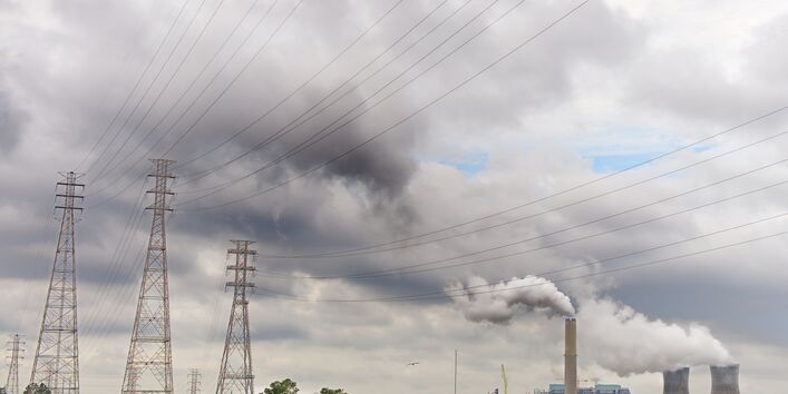 Cloudy landscape with power lines and power plant