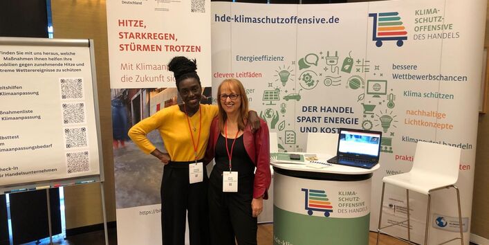Das Zweierteam von HDE-Adapt vor dem Stand auf dem Handelsimmobilienkongress.
